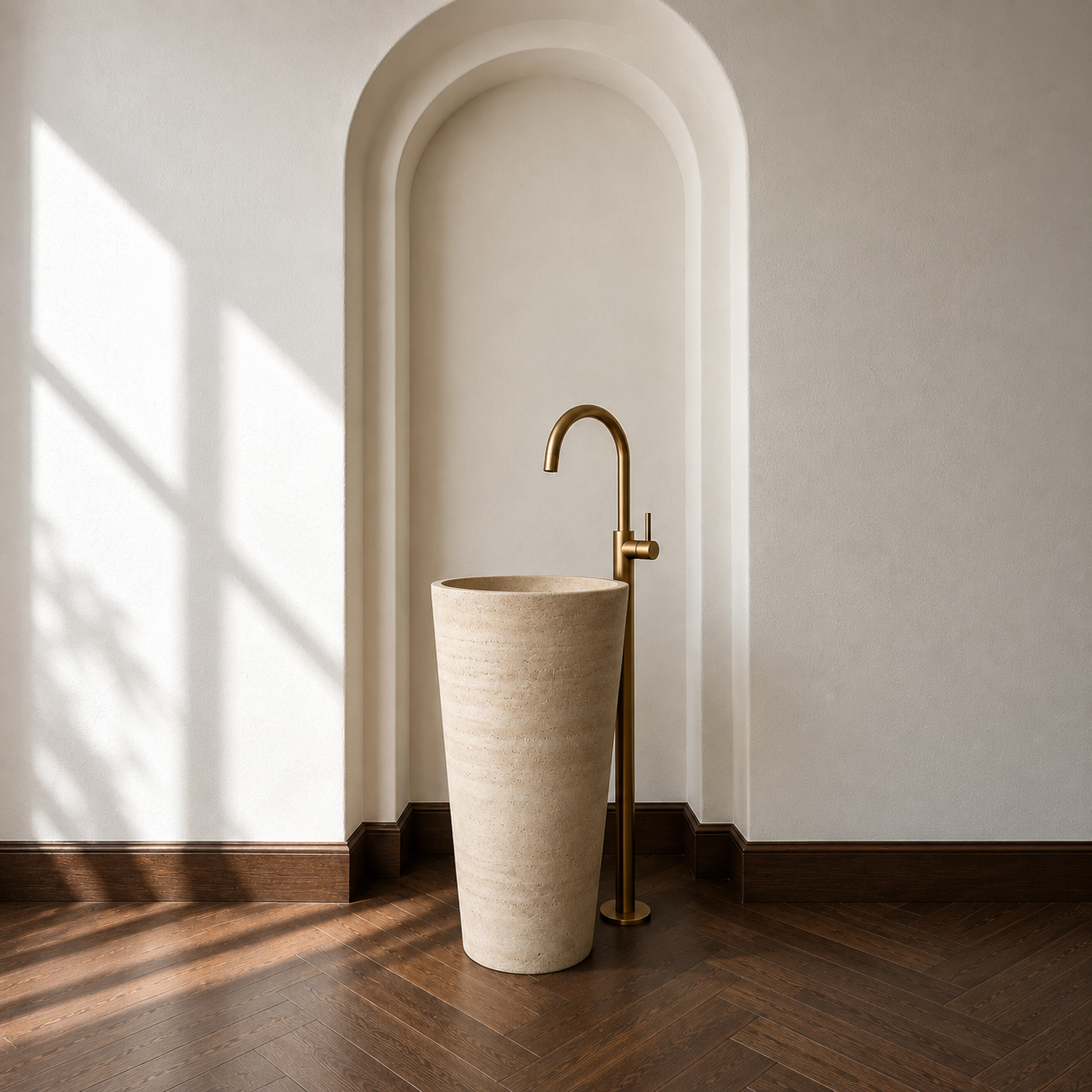 Freestanding stone wash basin with brass fittings in an arched niche by Studio IB Milano